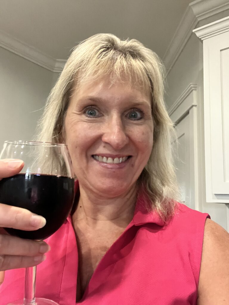 Dawn raising a glass of red wine